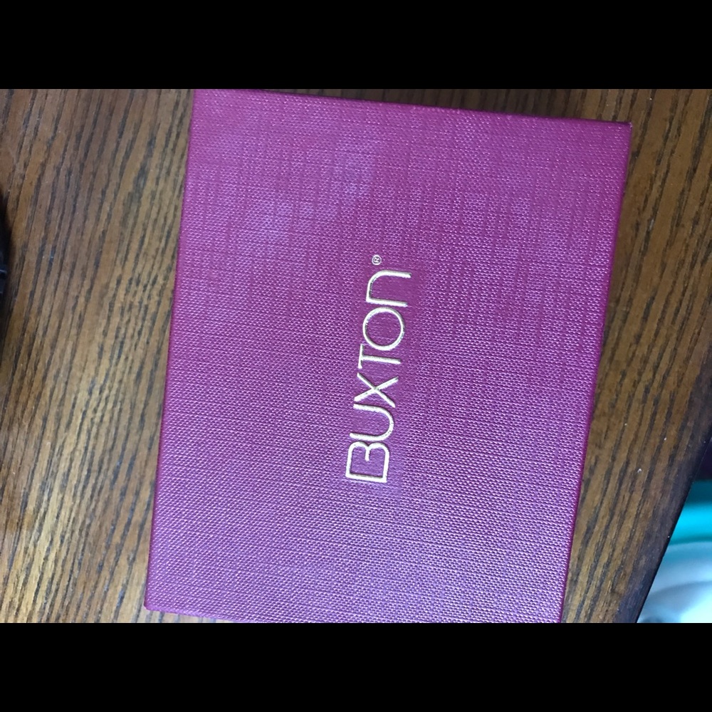 Woman’s Wine colored Buxton Tri Fold Wallet